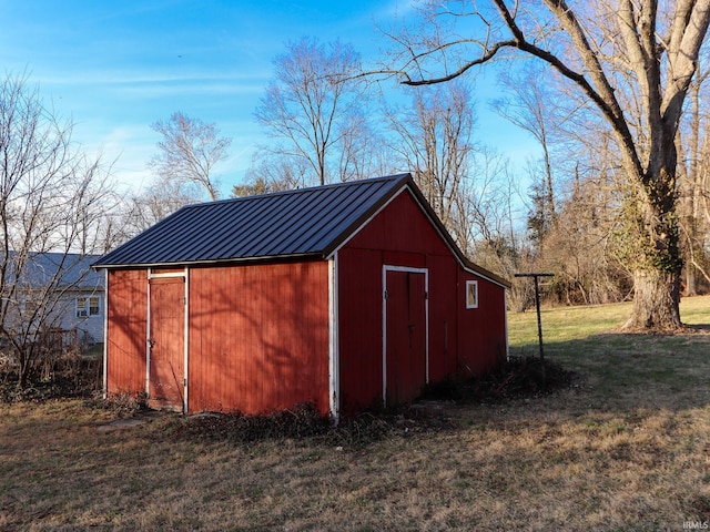 view of outbuilding featuring a yard