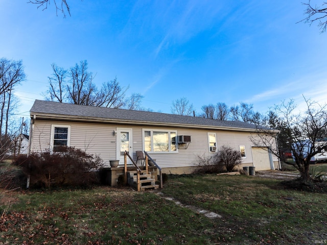 view of front of house with a front lawn and a wall mounted AC