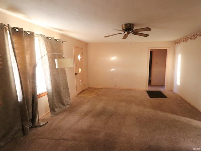 spare room featuring carpet flooring and ceiling fan