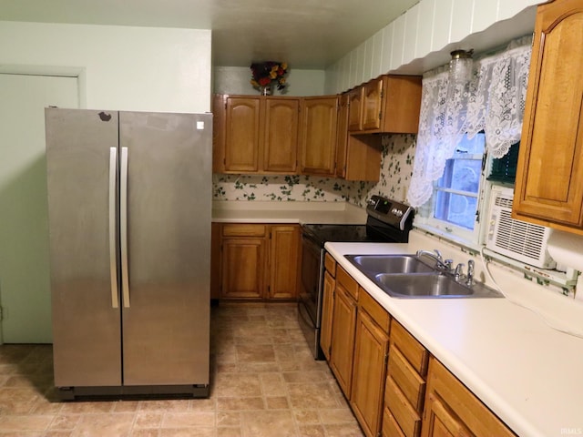 kitchen featuring range with electric stovetop, stainless steel refrigerator, and sink