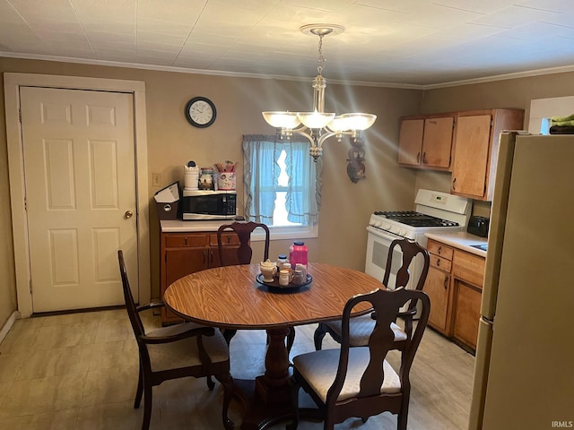 dining space with crown molding and a notable chandelier