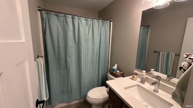 bathroom with vanity, curtained shower, and toilet