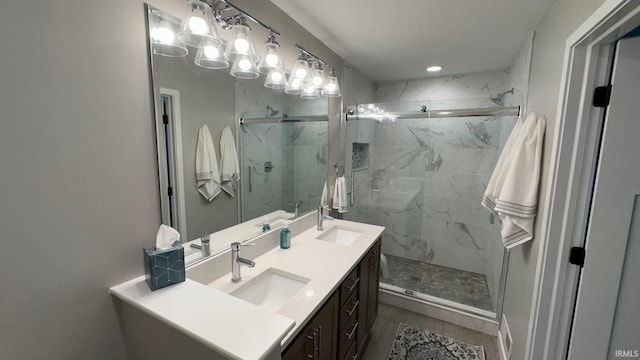 bathroom with vanity and a shower with shower door