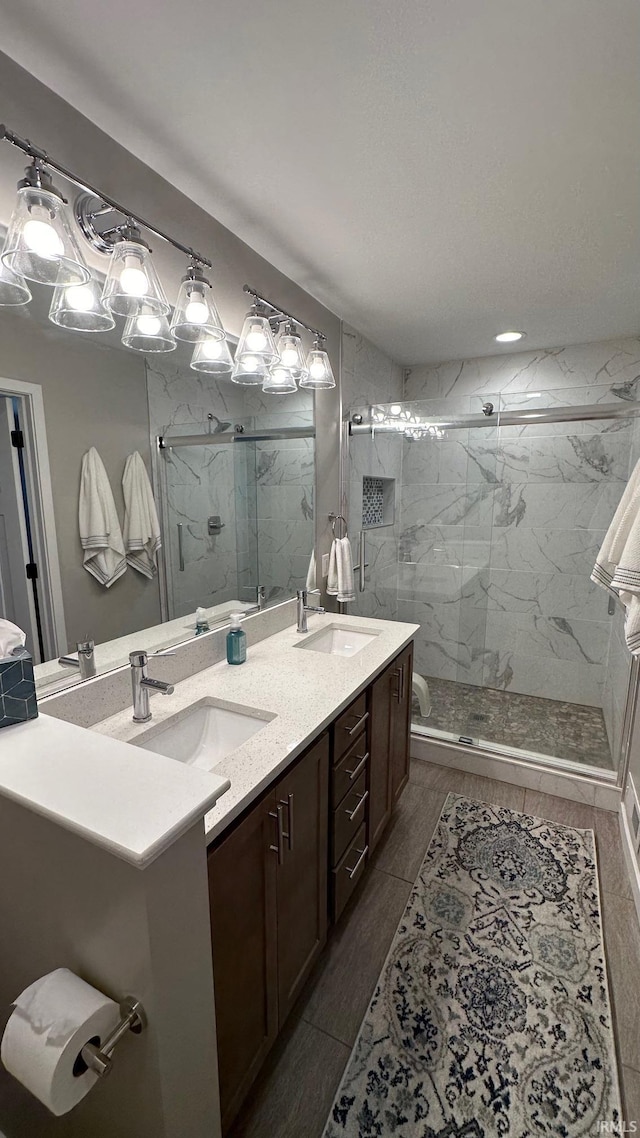 bathroom with vanity and a shower with shower door