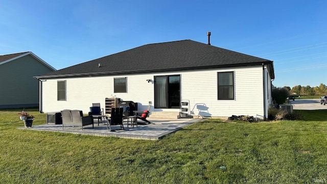 rear view of property featuring a lawn and a patio area