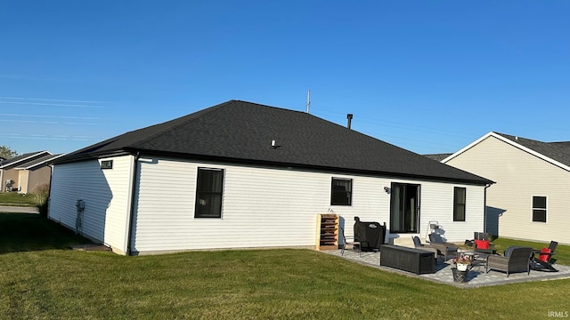 rear view of house with outdoor lounge area, a patio area, and a yard