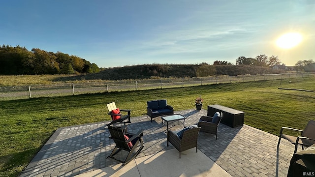 view of patio / terrace with an outdoor living space and a rural view