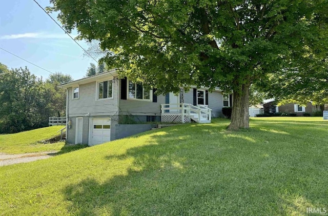 view of front of property featuring a garage and a front lawn