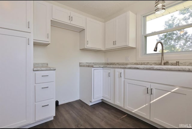 kitchen featuring white cabinetry and dark wood-type flooring