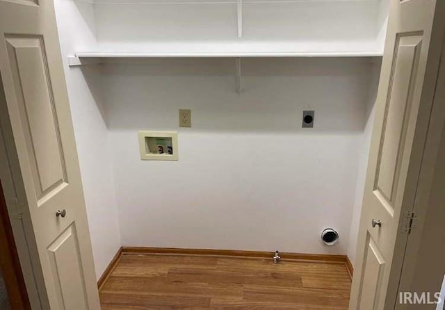 clothes washing area featuring hookup for a gas dryer, hardwood / wood-style floors, washer hookup, and hookup for an electric dryer