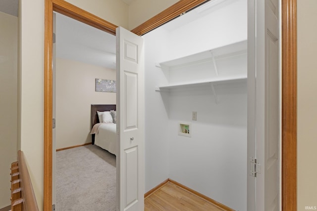 laundry room featuring light hardwood / wood-style floors and hookup for a washing machine