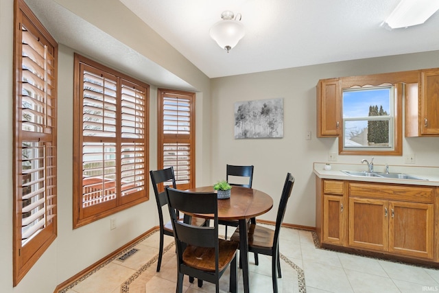 dining room with light tile patterned floors and sink