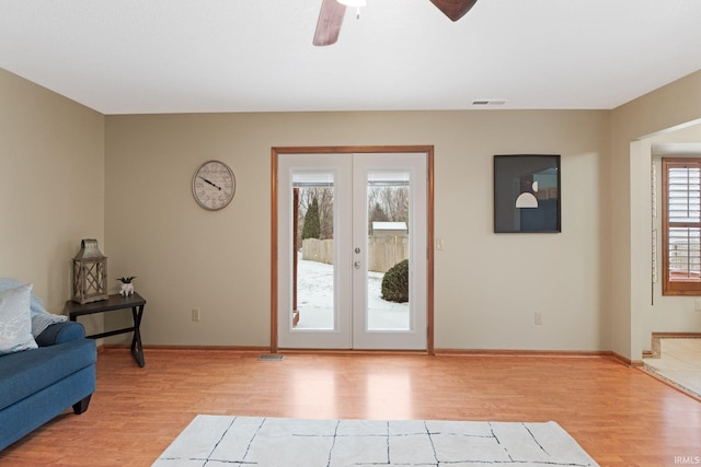 doorway to outside with french doors, light hardwood / wood-style floors, ceiling fan, and a healthy amount of sunlight