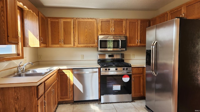 kitchen featuring sink, light tile patterned floors, and stainless steel appliances