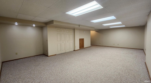 basement with a drop ceiling and carpet floors