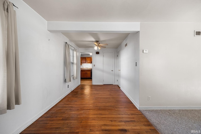 corridor with hardwood / wood-style floors