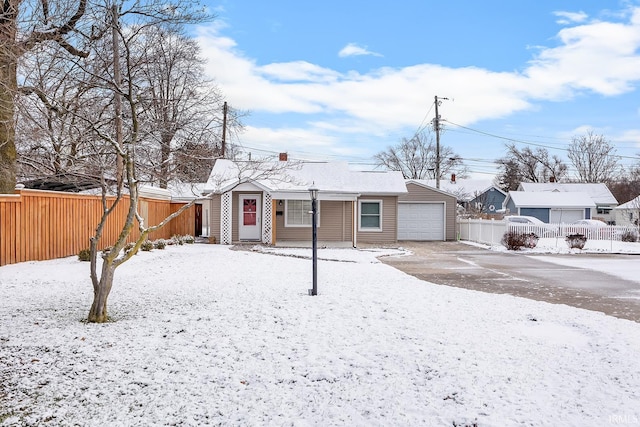 snow covered property with a garage