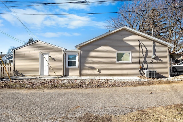 rear view of property featuring central air condition unit