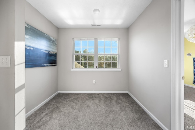 unfurnished room featuring light carpet