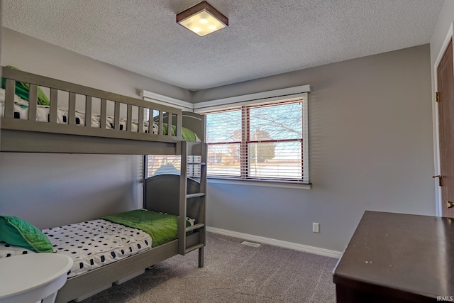 carpeted bedroom with a textured ceiling