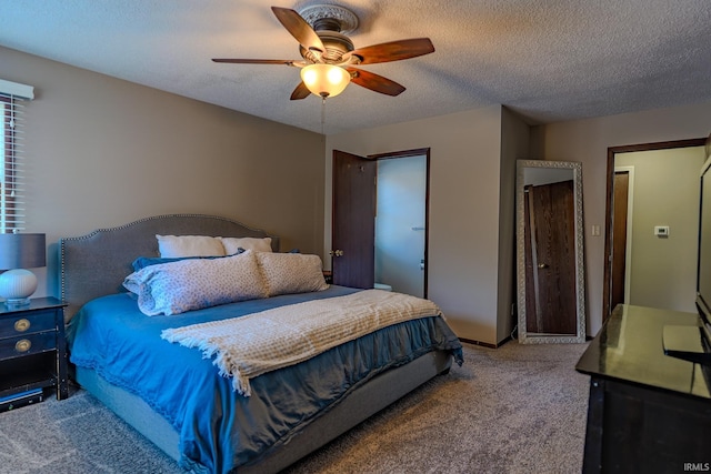 carpeted bedroom featuring ceiling fan and a textured ceiling