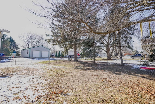 view of yard with a garage and an outdoor structure