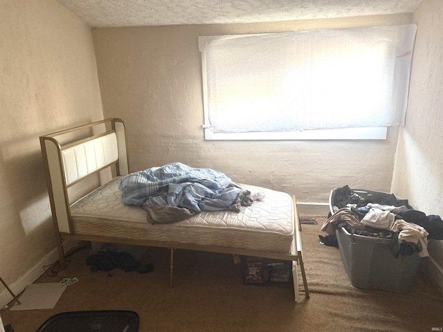 bedroom with carpet flooring and a textured ceiling