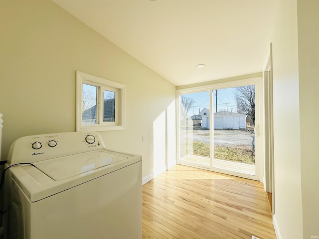 clothes washing area featuring washer / dryer and light wood-type flooring