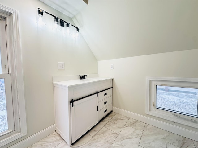 bathroom with vanity and lofted ceiling