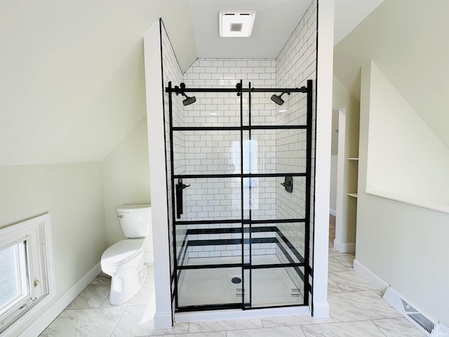 bathroom with toilet, walk in shower, and vaulted ceiling