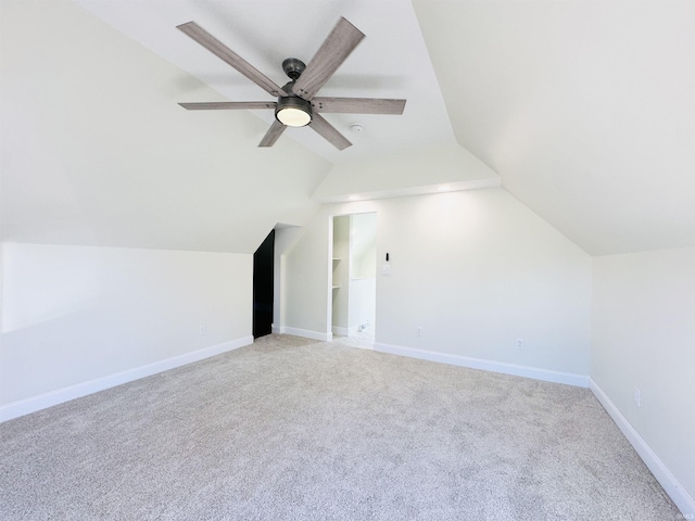 additional living space with light carpet, built in features, ceiling fan, and lofted ceiling