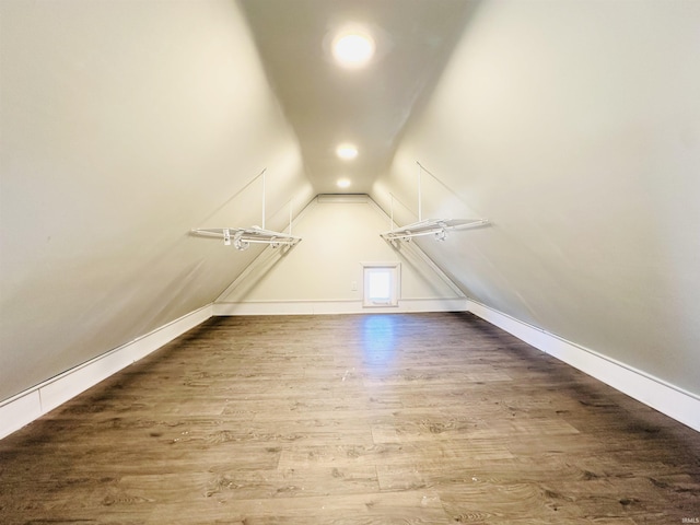 spacious closet featuring wood-type flooring and vaulted ceiling