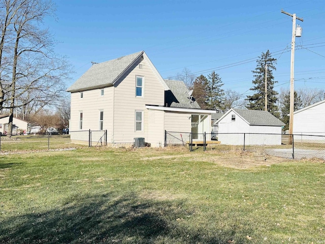 rear view of house with a yard