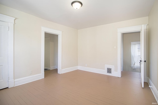 unfurnished room with light hardwood / wood-style flooring