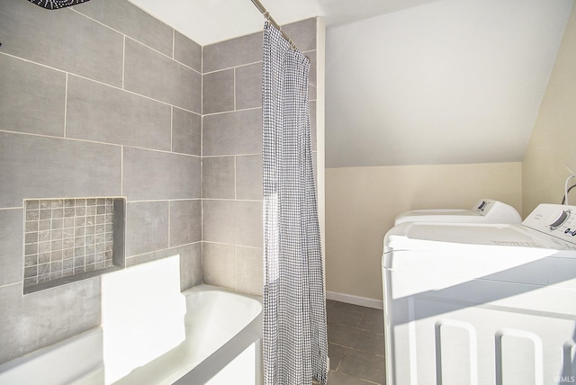 bathroom with independent washer and dryer, vaulted ceiling, tile patterned floors, and shower / bath combination with curtain