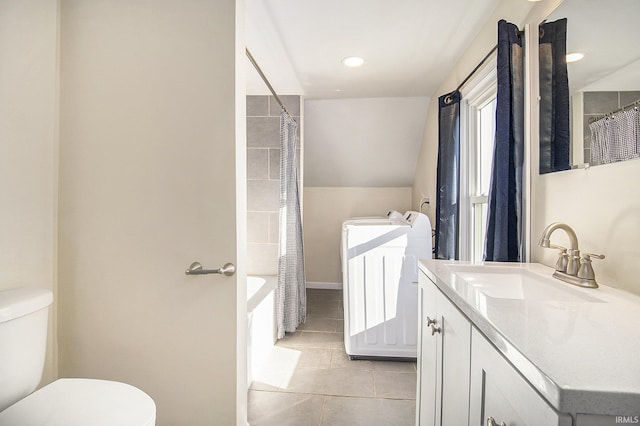 full bathroom featuring separate washer and dryer, tile patterned floors, toilet, vanity, and shower / tub combo