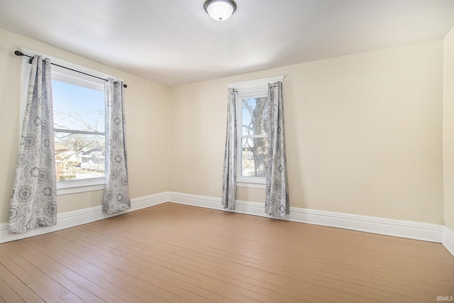 unfurnished room with hardwood / wood-style flooring