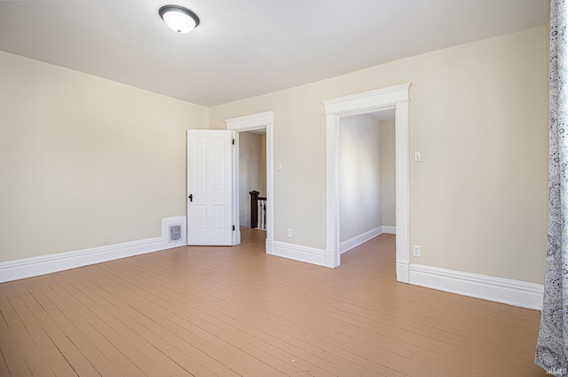 spare room with light hardwood / wood-style floors