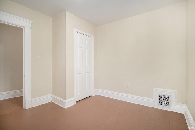 unfurnished bedroom featuring a closet and hardwood / wood-style floors