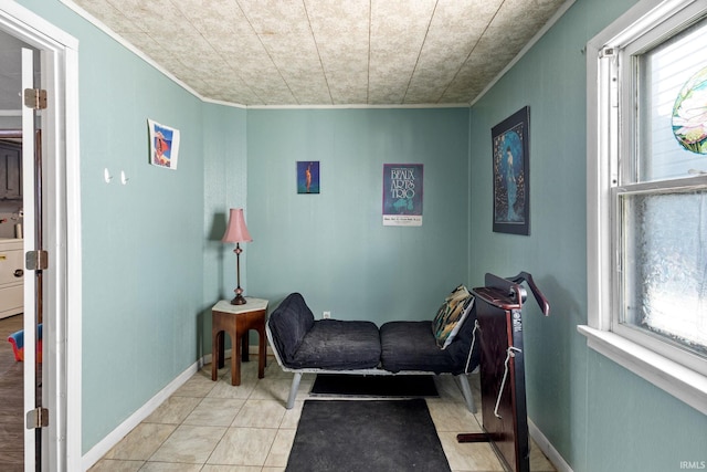 sitting room with light tile patterned floors, a healthy amount of sunlight, and ornamental molding