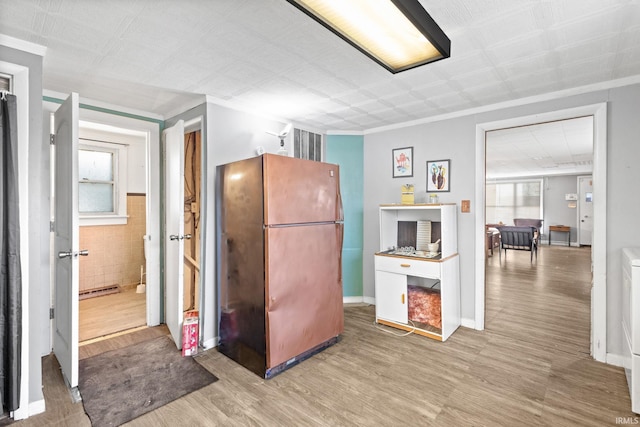 kitchen featuring light hardwood / wood-style flooring and fridge