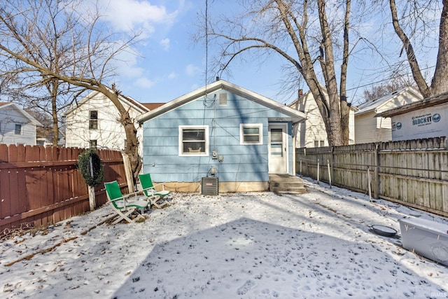 snow covered property with central AC unit