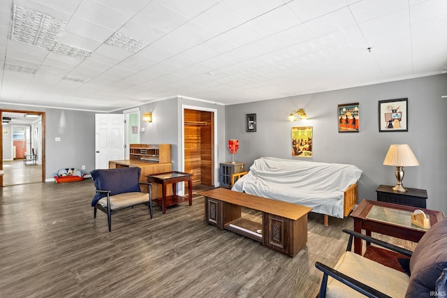 bedroom with dark hardwood / wood-style floors and a closet