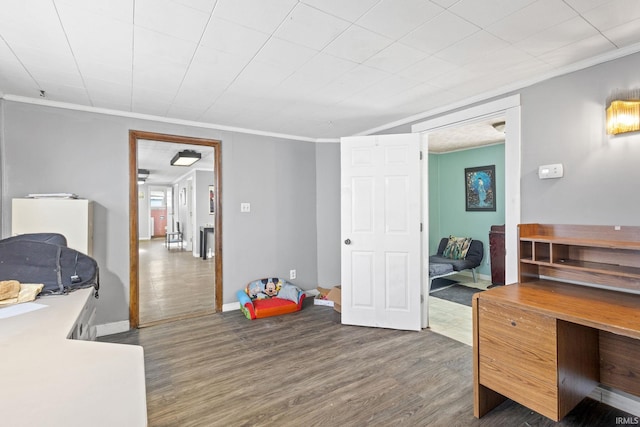 office area with dark hardwood / wood-style floors and crown molding