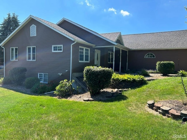 rear view of property with a lawn