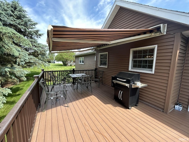 wooden deck featuring a grill