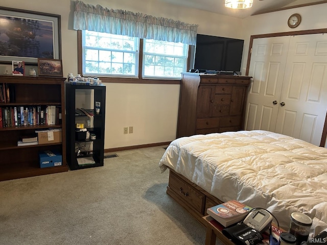 bedroom with light carpet and a closet