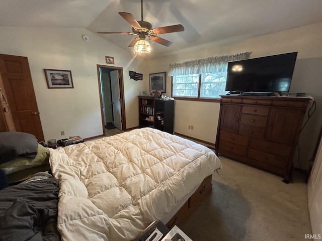 bedroom with ceiling fan, light carpet, and vaulted ceiling