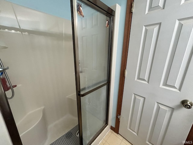 bathroom with tile patterned flooring and an enclosed shower