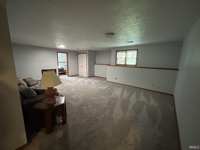 unfurnished living room featuring a textured ceiling and carpet floors